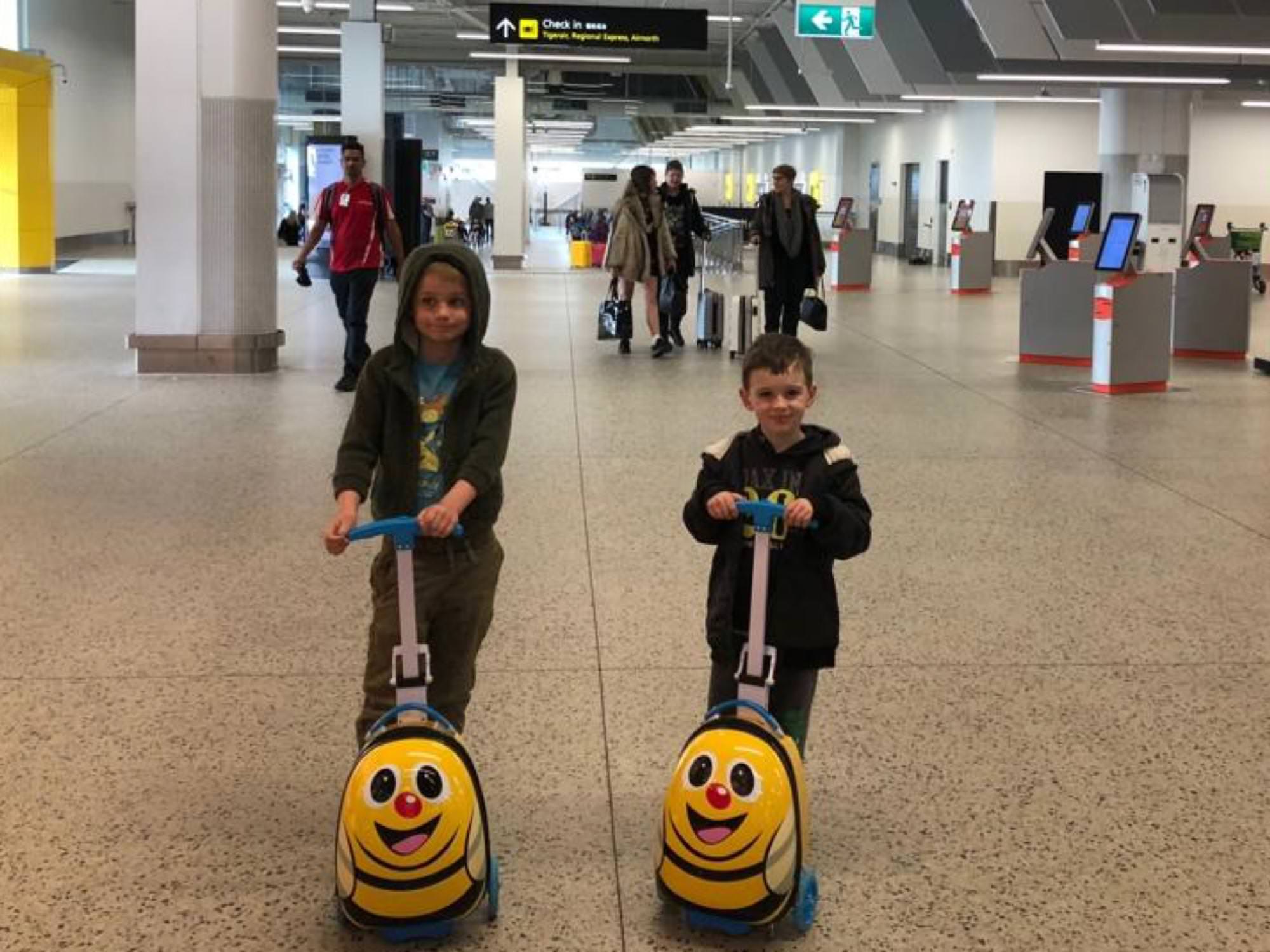 Boys on scooters in airport