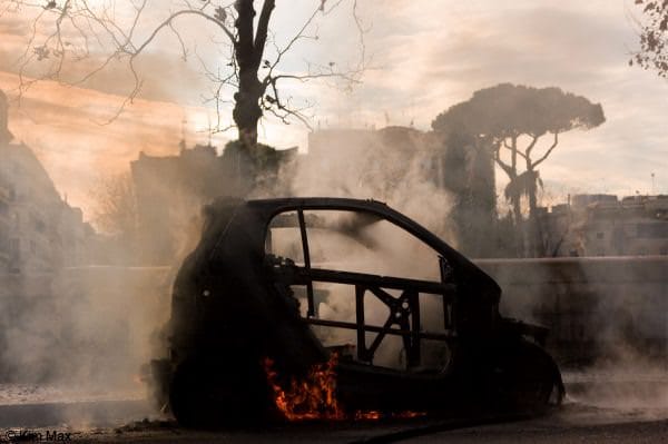 december riots in rome italy - smart car burns