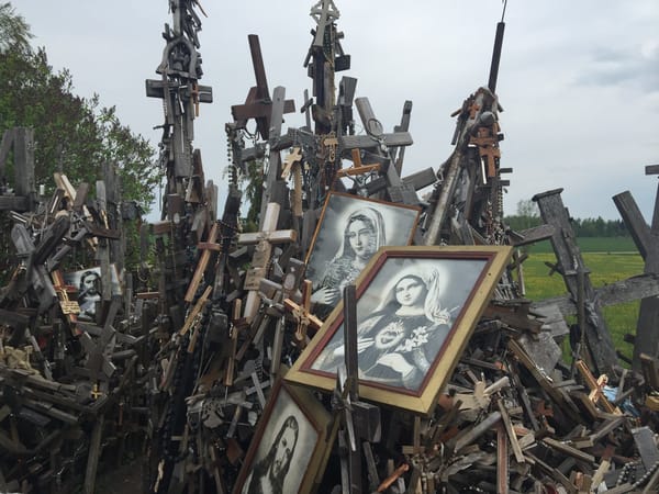 Dozens of crosses of many sizes huddle together, with a couple of pictures of the Virgin Mary amongst them.