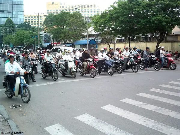 crazy mopeds and scooters and cycles on the road in saigon ho chi minh city vietnam