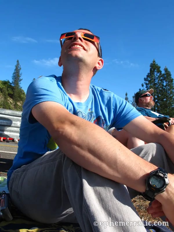 Meteorologist Joe Pollina watches the eclipse begin photo