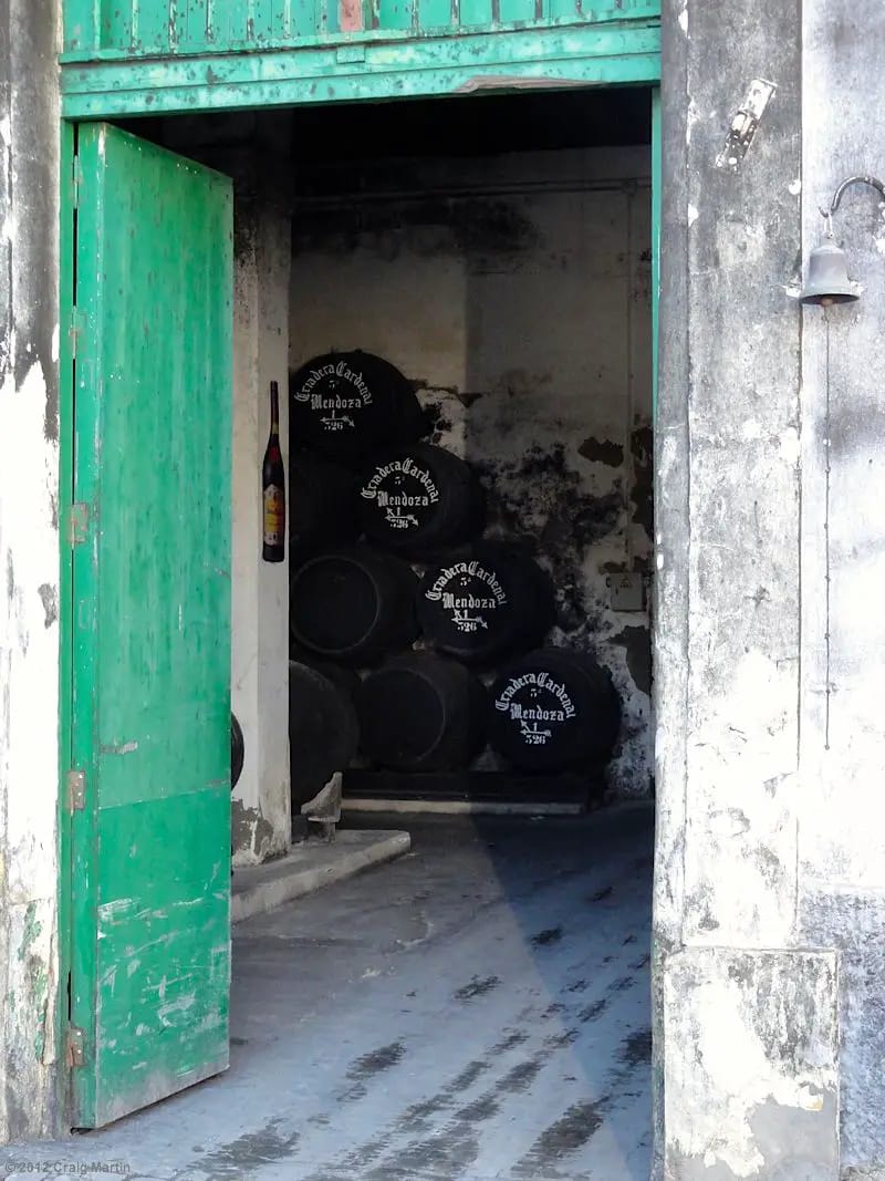 The barrels are stacked in well-ventilated cellars.